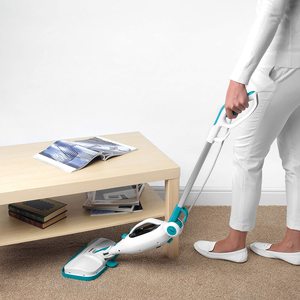 Beldray Steam Cleaner in use underneath furniture.