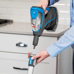 Bissell Power Fresh Slim Steam Mop in use as a hand-held cleaner.