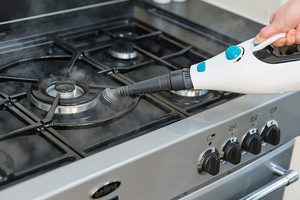 Russell Hobbs Neptune Multi Function Steam Mop being used as a hand-held appliance.