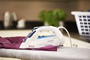 Tefal Smart Protect Iron on an ironing board.