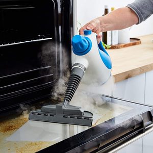 Tower Handheld Steam Cleaner in use.